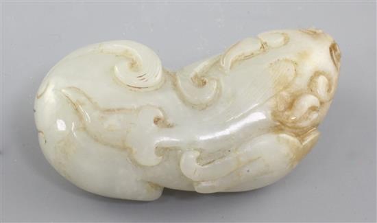 A Chinese pale celadon and russet jade figure of a recumbent beast, Qing dynasty, 5.1cm